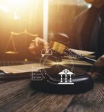 justice-and-law-concept-male-judge-in-a-courtroom-on-wooden-table-and-counselor-or-male-lawyer-working-in-office-legal-law-advice-and-justice-concept-free-photo